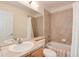 Bright bathroom with neutral tile, single sink vanity, ample lighting, and a bathtub/shower combo at 479 Blue Lake Trl, Lafayette, CO 80026