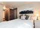 Comfortable bedroom with neutral walls, hardwood floors, skyline art, and ample closet space at 479 Blue Lake Trl, Lafayette, CO 80026