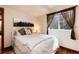 Cozy bedroom with hardwood floors, large window, stylish decor, and comfortable bed at 479 Blue Lake Trl, Lafayette, CO 80026