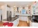 Well-equipped kitchen with granite countertops, stainless steel appliances, a center island, and a stylish vent hood at 479 Blue Lake Trl, Lafayette, CO 80026