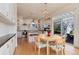 Eat-in kitchen showcasing white cabinetry, stainless steel appliances, and a sliding glass door to the outdoor patio at 479 Blue Lake Trl, Lafayette, CO 80026