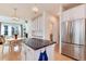 Open concept kitchen with an island, stainless appliances, and a dining area that connects to the living room at 479 Blue Lake Trl, Lafayette, CO 80026