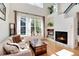 Bright living room featuring hardwood floors, a fireplace, and large windows offering plenty of natural light at 479 Blue Lake Trl, Lafayette, CO 80026