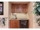 Basement wet bar with built-in shelving, sink, mini refrigerator, and granite countertops at 479 Blue Lake Trl, Lafayette, CO 80026