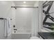 Clean bathroom with a bathtub, white tile, and simple decor for a relaxing space at 13860 Ash Cir, Thornton, CO 80602