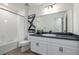 Stylish bathroom features a single vanity with modern fixtures and bathtub with shower at 13860 Ash Cir, Thornton, CO 80602