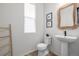 Cozy bathroom has a pedestal sink, woven mirror, and wood ladder at 13860 Ash Cir, Thornton, CO 80602