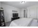 Bedroom with a TV, closet, and ensuite bathroom access, perfect for relaxation at 13860 Ash Cir, Thornton, CO 80602