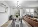 Open-concept dining area with stylish table, modern decor, and connection to the living room at 13860 Ash Cir, Thornton, CO 80602