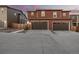 Two-story home exterior featuring a double garage and neutral color scheme at 13860 Ash Cir, Thornton, CO 80602