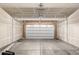 Spacious two-car garage with drywall, showing structural supports and door mechanics at 13860 Ash Cir, Thornton, CO 80602