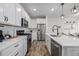 This kitchen boasts stainless steel appliances, sleek white cabinets, and quartz countertops at 13860 Ash Cir, Thornton, CO 80602