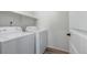 Clean laundry room featuring a white washer and dryer with a shelf above at 13860 Ash Cir, Thornton, CO 80602