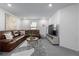 Inviting living room with brown leather sectional, tv, and neutral tones at 13860 Ash Cir, Thornton, CO 80602