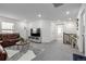 Bright living room featuring a brown leather couch, gray carpet, and modern decor at 13860 Ash Cir, Thornton, CO 80602