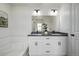 Bright bathroom featuring double sinks, a large mirror, and a soaking tub at 13860 Ash Cir, Thornton, CO 80602