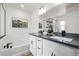 Elegant bathroom with double sinks, a soaking tub, and a separate glass-enclosed shower at 13860 Ash Cir, Thornton, CO 80602
