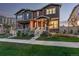 Beautiful exterior of a multi-story home with a well-manicured lawn and inviting front porch at 13860 Ash Cir, Thornton, CO 80602