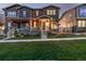 Inviting two-story townhome with a cozy front porch and lush green lawn at 13860 Ash Cir, Thornton, CO 80602