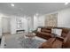 Comfortable living room featuring a brown leather sectional and stylish modern decor at 13860 Ash Cir, Thornton, CO 80602