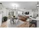 Bright, open-concept living room with modern furniture and sliding glass doors at 13860 Ash Cir, Thornton, CO 80602