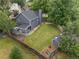 Aerial view of a fully fenced backyard with a large lawn, storage shed, and wooden deck at 18056 E Bellewood Dr, Aurora, CO 80015