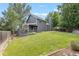 Large private backyard with green lawn, mature trees and a covered patio and deck for entertaining at 18056 E Bellewood Dr, Aurora, CO 80015