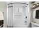 Bright bathroom features a shower with white tile surround, built-in niche, and sleek, modern fixtures at 18056 E Bellewood Dr, Aurora, CO 80015