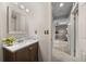 Bathroom with a mirror, vanity, and sink with mosaic tile backsplash at 18056 E Bellewood Dr, Aurora, CO 80015