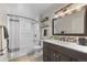 Well-lit bathroom featuring tiled shower and bathtub combo, sleek fixtures, and ample counter space at 18056 E Bellewood Dr, Aurora, CO 80015