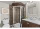 Bathroom with a shower, toilet, vanity, and sink with mosaic tile backsplash at 18056 E Bellewood Dr, Aurora, CO 80015
