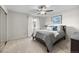 Calming primary bedroom with plush carpet, ceiling fan, and large window with natural light at 18056 E Bellewood Dr, Aurora, CO 80015