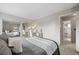 Bedroom features mirrored closet doors, a desk, and an ensuite bathroom, offering convenience and style at 18056 E Bellewood Dr, Aurora, CO 80015