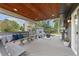 Spacious covered deck with benches, table, and outdoor seating area overlooking the yard at 18056 E Bellewood Dr, Aurora, CO 80015