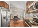 Open layout kitchen and dining area features stainless steel appliances, and access to upstairs at 18056 E Bellewood Dr, Aurora, CO 80015