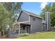 Two-story home with a landscaped yard, deck, and gray siding at 18056 E Bellewood Dr, Aurora, CO 80015