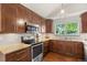 Classic kitchen features wood cabinets, granite countertops, stainless steel appliances, and ample natural light at 18056 E Bellewood Dr, Aurora, CO 80015