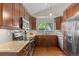 Charming kitchen boasts stainless steel appliances, granite countertops, and bright natural lighting at 18056 E Bellewood Dr, Aurora, CO 80015