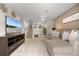 Comfortable living room featuring plush seating, carpeted floors, and a stylish stairway, perfect for relaxation at 18056 E Bellewood Dr, Aurora, CO 80015