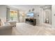 Bright living room with a sliding door, large windows, stylish decor, and a view to the bathroom at 18056 E Bellewood Dr, Aurora, CO 80015