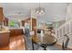 Open kitchen, dining and living space features hardwood floors and stainless steel appliances at 18056 E Bellewood Dr, Aurora, CO 80015