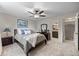 Comfortable main bedroom featuring ceiling fan, soft carpet, and a connected bathroom for added convenience at 18056 E Bellewood Dr, Aurora, CO 80015