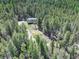 Expansive aerial view of a home, highlighting its secluded location and vast surrounding forest at 8340 London Ln, Conifer, CO 80433