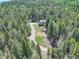 Stunning aerial view of a home set amongst lush trees and a winding driveway, emphasizing its privacy at 8340 London Ln, Conifer, CO 80433