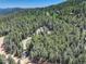 Scenic aerial view of a home surrounded by dense green forests, showcasing its mountain location at 8340 London Ln, Conifer, CO 80433