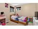 Bedroom with a wood-framed bed, natural light from two windows, and a vanity table at 8340 London Ln, Conifer, CO 80433