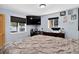 Bedroom featuring two windows and an entertainment center at 8340 London Ln, Conifer, CO 80433