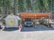 Features a truck parked under a covered carport with a shed, offering practical vehicle storage at 8340 London Ln, Conifer, CO 80433