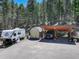 Property view with RV parking alongside a covered parking space and a storage shed for vehicles at 8340 London Ln, Conifer, CO 80433