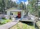 Inviting home featuring a cozy front porch and a spacious deck, ideal for relaxation and entertaining guests at 8340 London Ln, Conifer, CO 80433